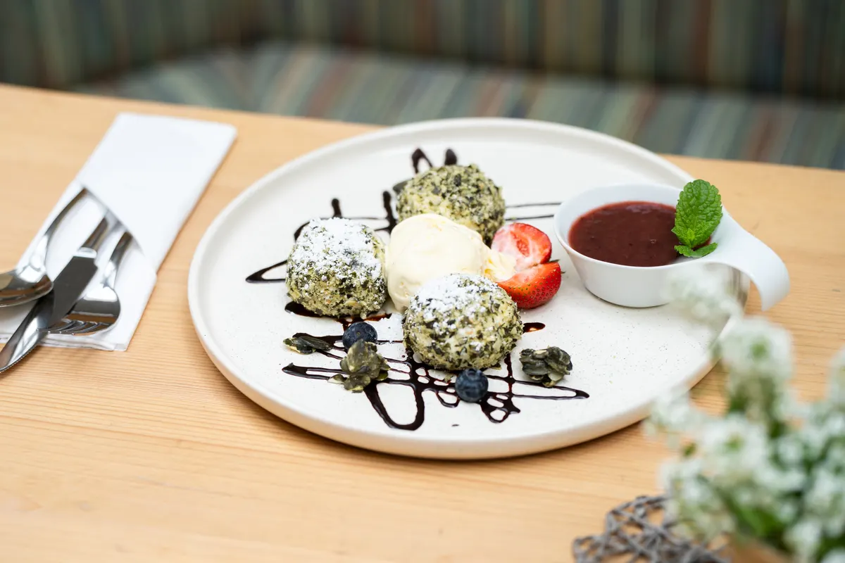 Dessert plate with vanilla ice cream and berry sauce at Restaurant Schachenwald