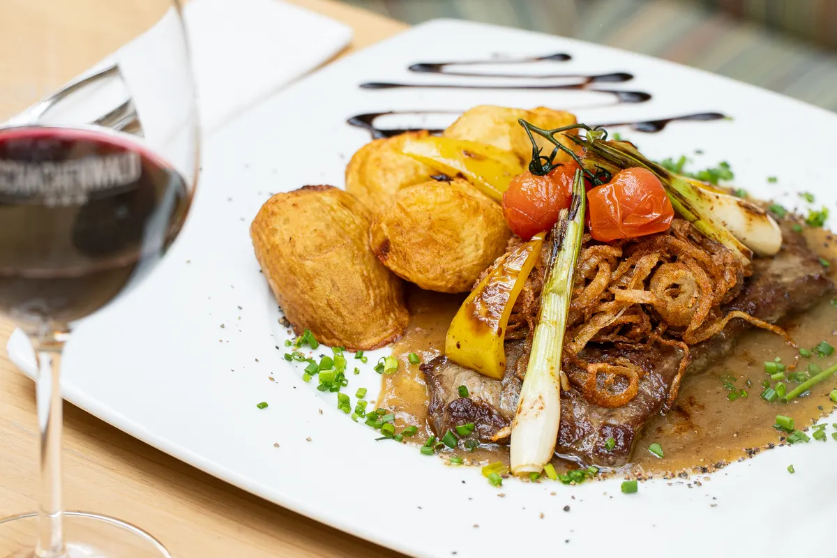 Beef steak with crispy onions and roasted potatoes at Restaurant Schachenwald